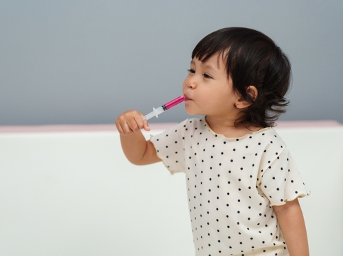Toddler taking medicine